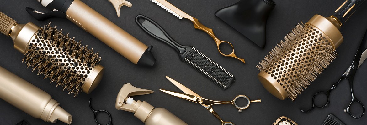 Full frame of professional hair dresser tools on black background